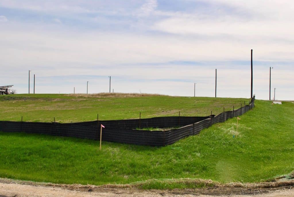a grassy field with a fence