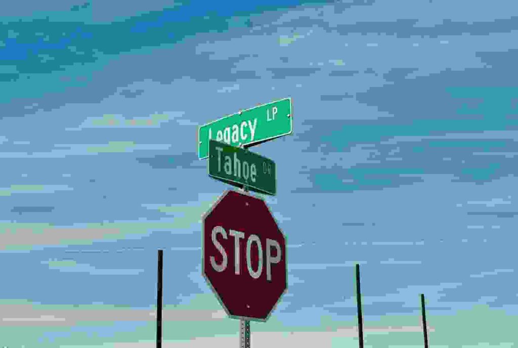 a stop sign with two street signs on top of it