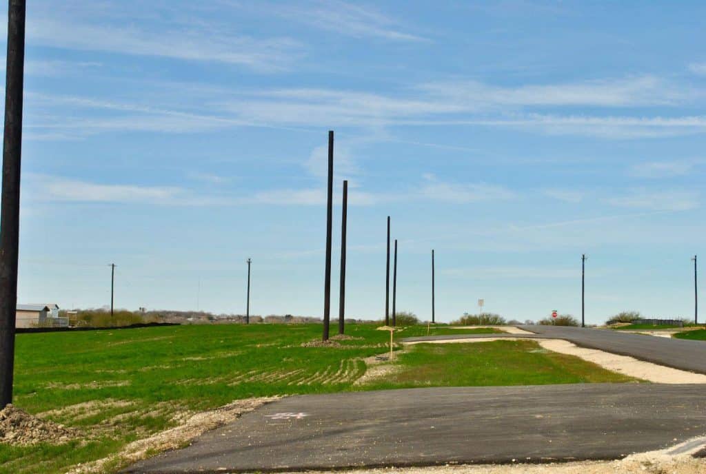 an empty road with a green field