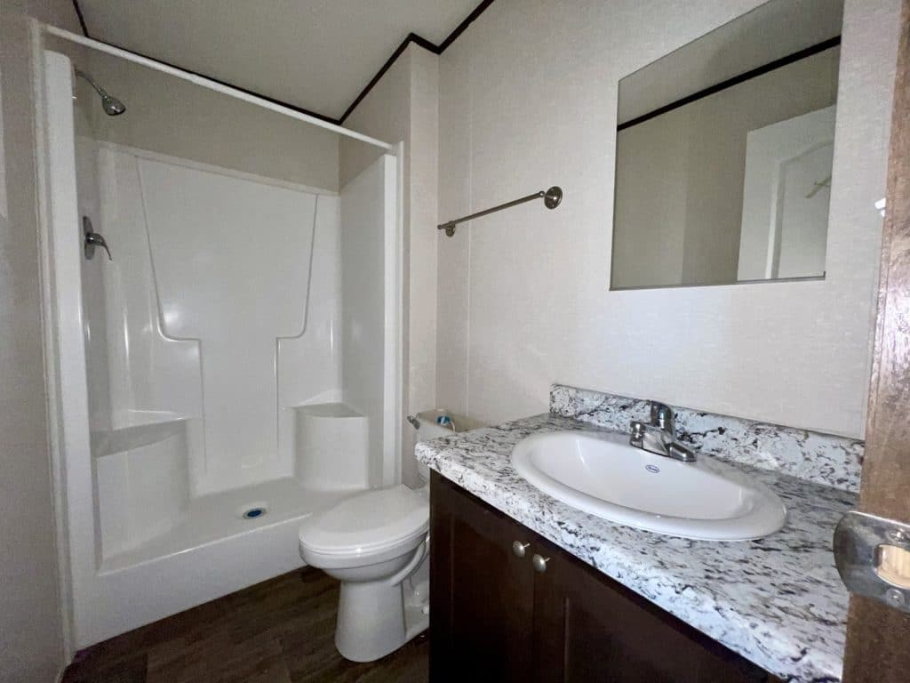 a bathroom with a sink, toilet, and bath tub shower
