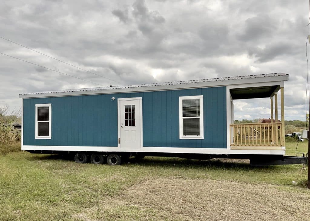 a blue and white tiny house on a trailer 2