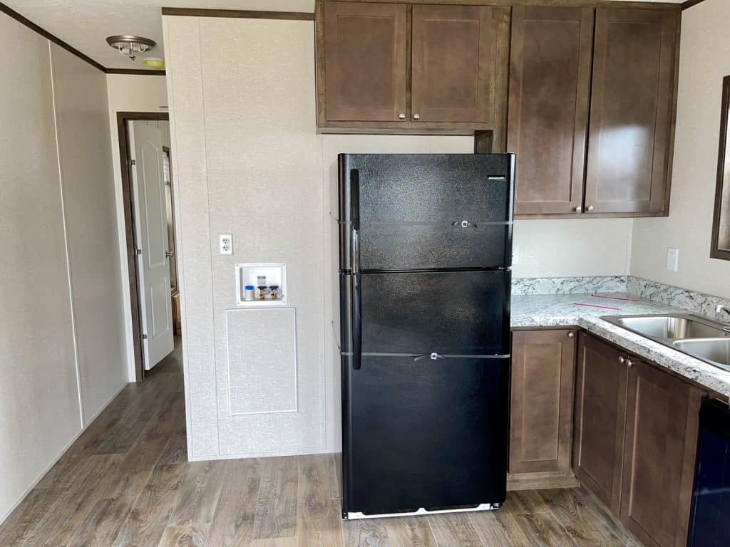 a black refrigerator inside of a kitchen