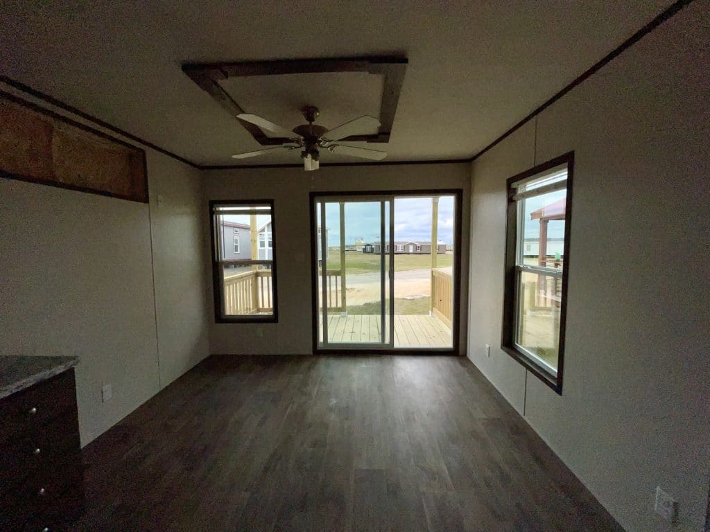 living room with a sliding glass door and ceiling fan