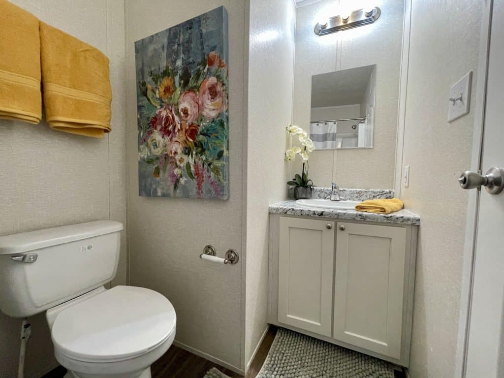 bathroom with toilet and white cabinetry