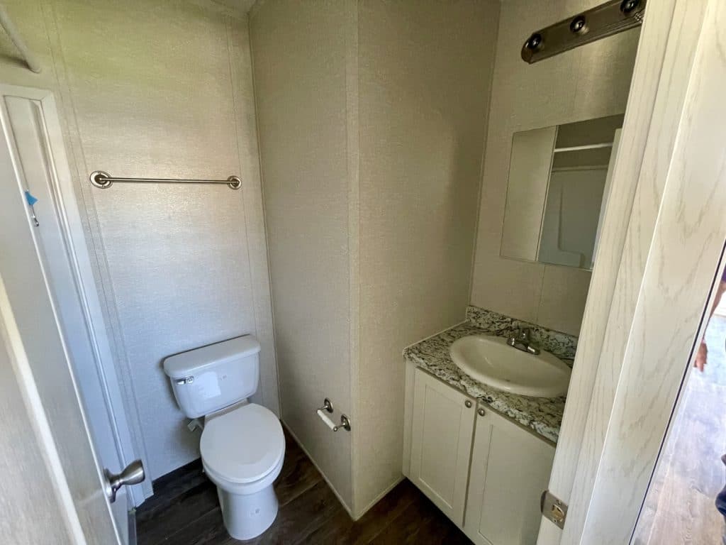 primary bathroom with white toilet and sink wide angle